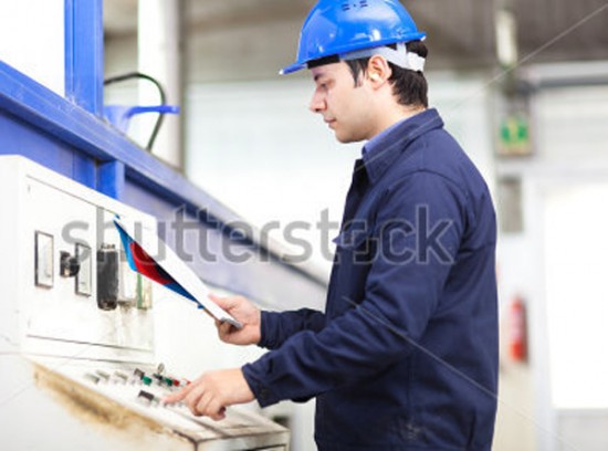 worker operating a rotational moulding machine